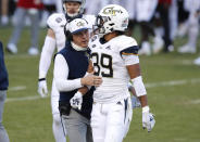 Georgia Tech head coach Geoff Collins talks to defensive back Wesley Walker (39) during an NCAA college football game against N.C. State in Raleigh, N.C., Saturday, Dec. 5, 2020. (Ethan Hyman/The News & Observer via AP, Pool)