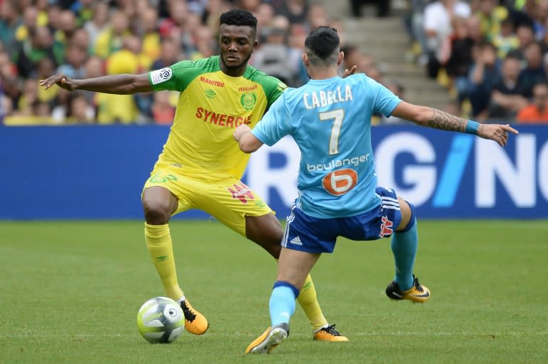 Nantes' defender Chidozie Awaziem (L) vies with Marseille's French midfielder Remy Cabella during the French L1 football match between Nantes and Olympique de Marseille on August 12, 2017