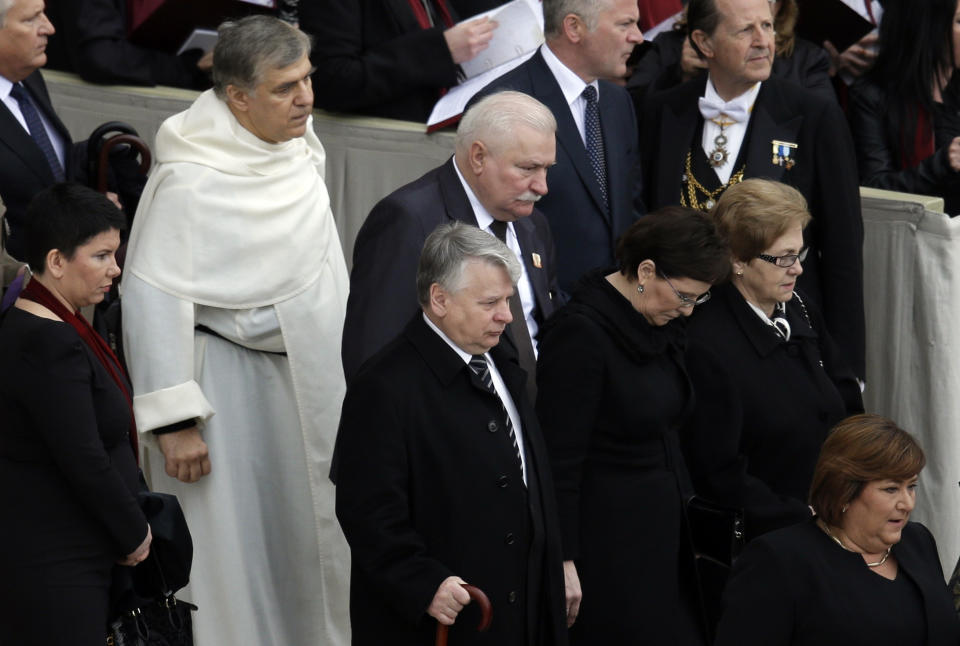 Lech Walesa, Poland's former president, center, arrives in St. Peter's Square at the Vatican, Sunday, April 27, 2014. Pope Francis has declared his two predecessors John XXIII and John Paul II saints in an unprecedented canonization ceremony made even more historic by the presence of retired Pope Benedict XVI. . (AP Photo/Alessandra Tarantino)