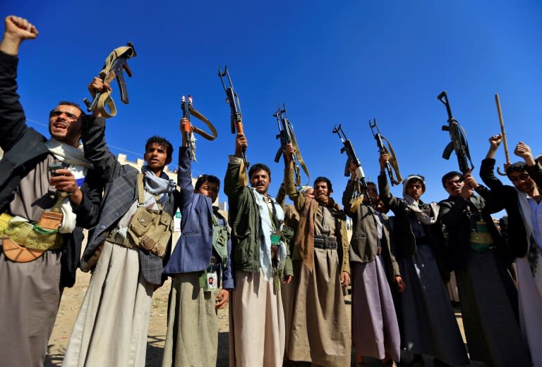 Armed Yemeni men brandish their weapons in the capital Sanaa to show their support for the Huthi rebels against the Saudi-led intervention on December 13, 2018