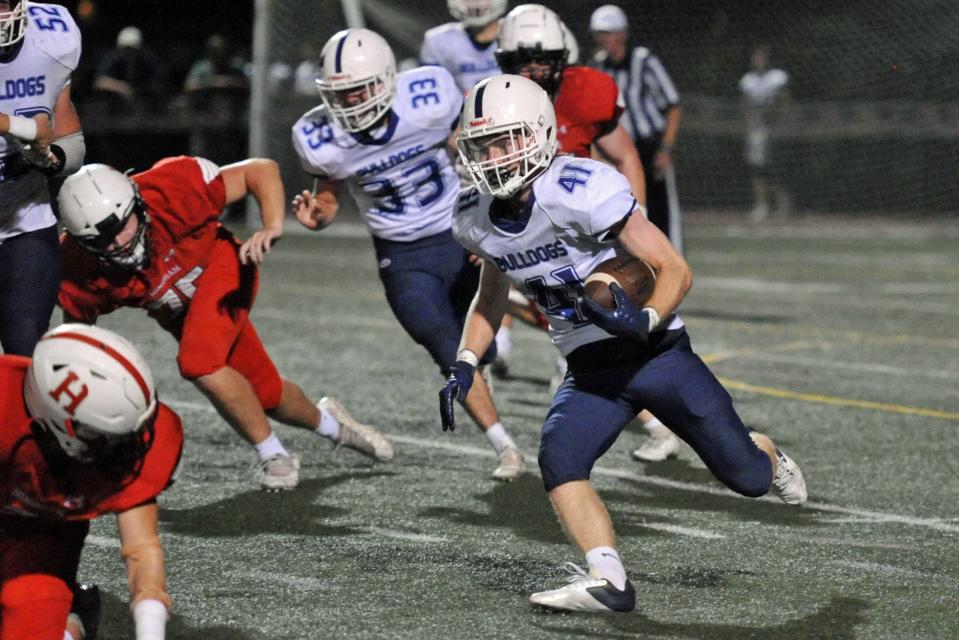 Rockland's Jacob Coulstring, right, races downfield as Hingham defenders move in during the high school football season season opener at Hingham High School, Friday, Sept. 9, 2022.