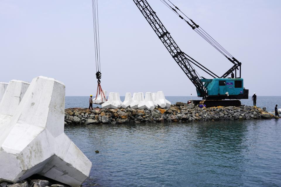 Construction workers build a sea wall along the Arabian Sea in the Chellanam area of Kochi, Kerala state, India, Feb. 28, 2023. Tens of millions of people in India live along coastlines and thus are exposed to major weather events. One common adaptation technique, in India and other countries hit hard by rising seas and oceanic storms, is to build sea walls. (AP Photo)