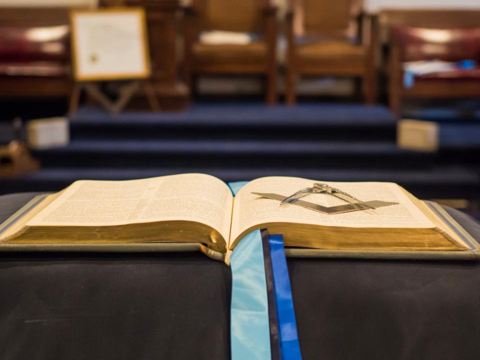 A Freemason book open at a Temple