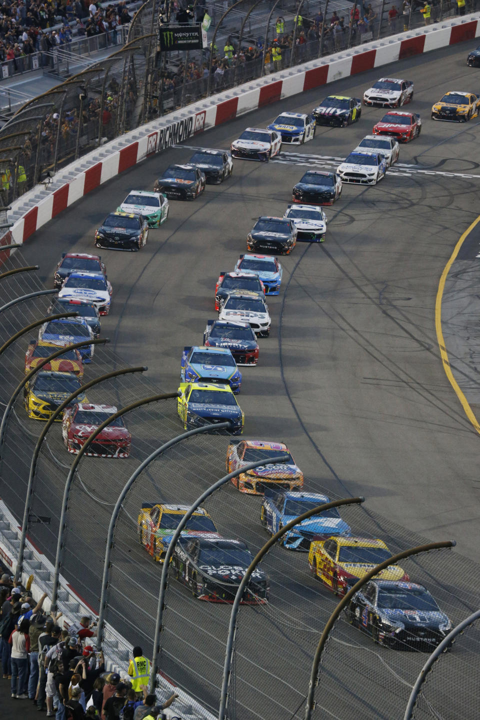 Kevin Harvick, lower right, leads the field at the start of the NASCAR Cup series auto race at Richmond Raceway in Richmond, Va., Saturday, April 13, 2019. (AP Photo/Steve Helber)