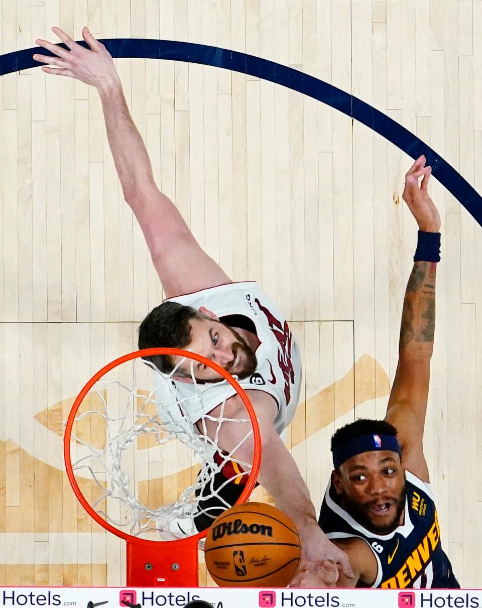 Denver Nuggets forward Bruce Brown (11) shoots the ball against Miami Heat forward Kevin Love (42).