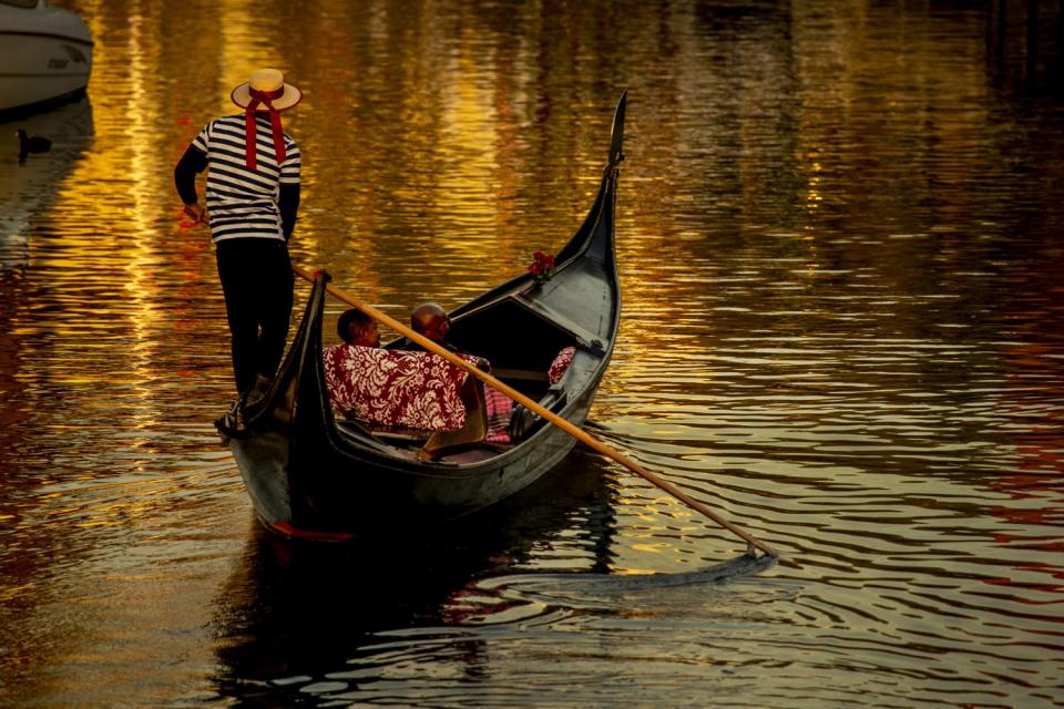 A couple on gondola ride around Naples Island in Long Beach