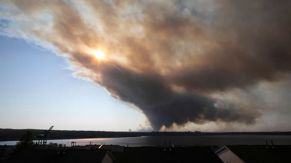 Thick plumes of smoke fill the sky as an out-of-control fire in a suburban community quickly spreads, engulfing multiple homes and forcing the evacuation of residents, in Halifax, Nova Scotia, on May 28. - Kelly Clark/The Canadian Press/AP
