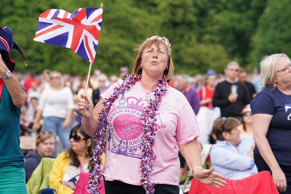 A lady watches a screen in St James's Park before the start of the Platinum Party at the Palace in front of Buckingham Palace (PA)