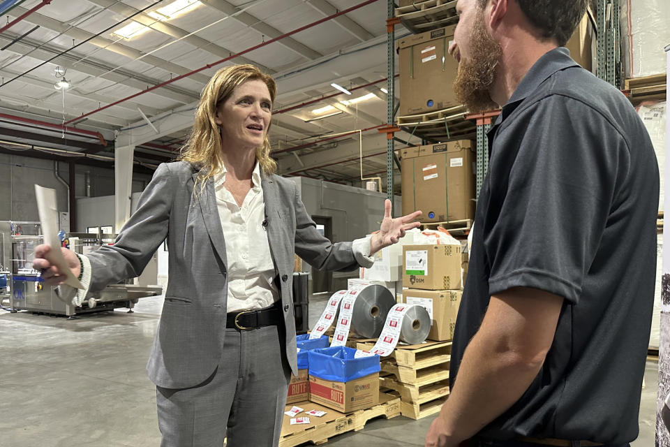 USAID Administrator Samantha Power talks with a worker Friday, May 3, 2024, during a tour of the factory where the nonprofit Mana makes emergency nutritional aid in Fitzgerald, Georgia. Power announced USAID is investing $200 million in emergency nutritional treatment for starving children as conflicts in Gaza, Sudan and elsewhere drive up the need. (AP Photo/Russ Bynum)