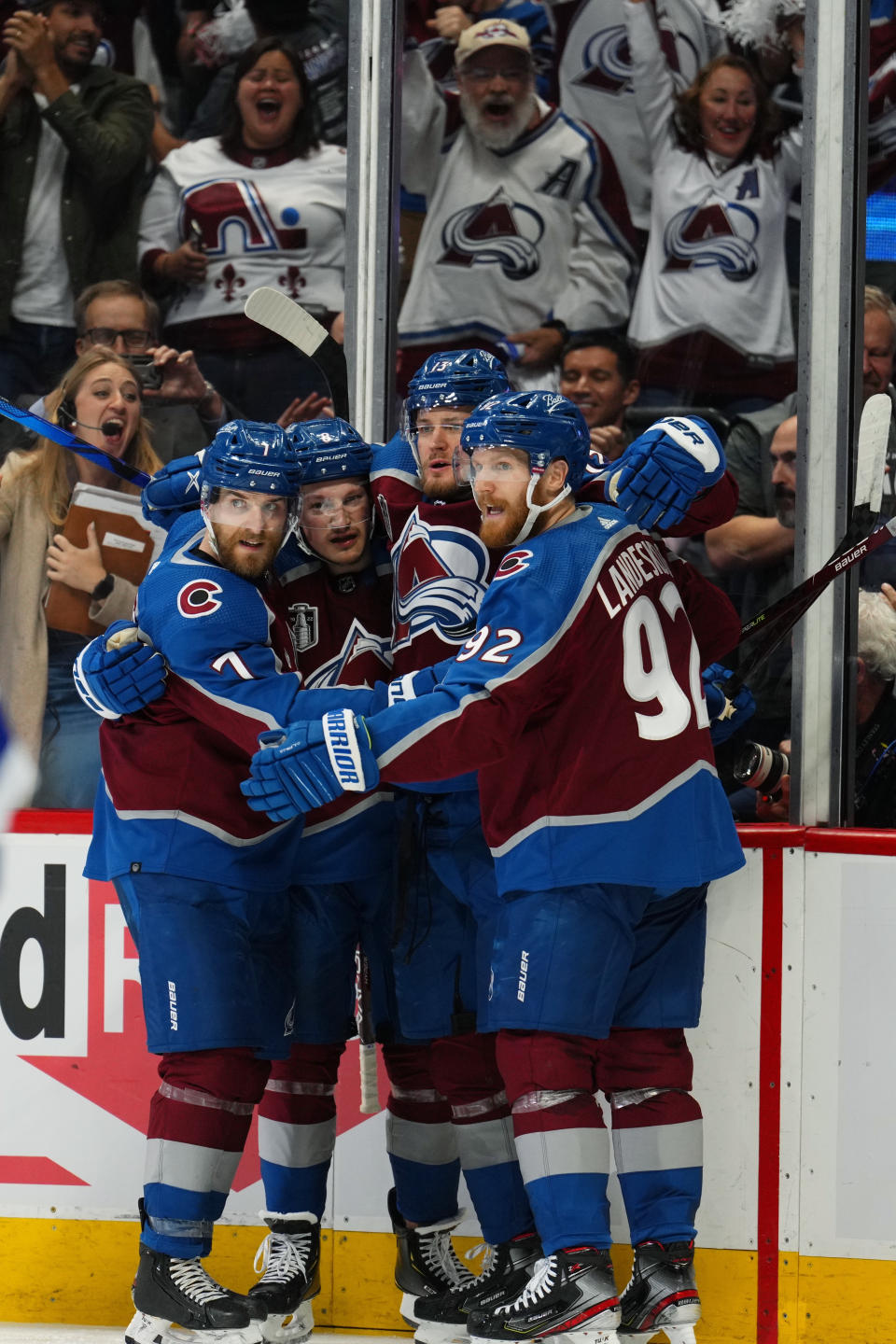 Colorado Avalanche right wing Valeri Nichushkin (13) celebrates a goal against the Tampa Bay Lightning with Devon Toews (7), Cale Makar (8) and Gabriel Landeskog (92) during the second period in Game 5 of the NHL hockey Stanley Cup Final, Friday, June 24, 2022, in Denver. (AP Photo/Jack Dempsey)