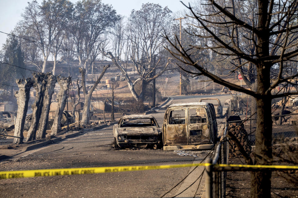 Vehicles and and homes destroyed by the Mill Fire line a neighborhood in Weed, Calif., on Saturday, Sept. 3, 2022. (AP Photo/Noah Berger)