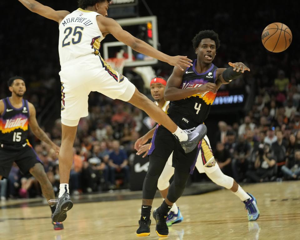 Apr 26, 2022; Phoenix, Ariz, U.S.;  Phoenix Suns guard Aaron Holiday (4) passes the ball against New Orleans Pelicans guard Trey Murphy III (25) during Game 5 of the Western Conference playoffs.