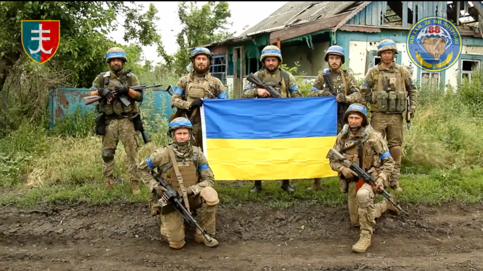 Soldiers of Ukraine's 35th Marine Brigade stand with a Ukrainian flag in what is claimed to be the liberated village of Storozhove in Donetsk Oblast on June 12, 2023. (Photo: 35th Marine Brigade via Anadolu Agency/Getty Images)