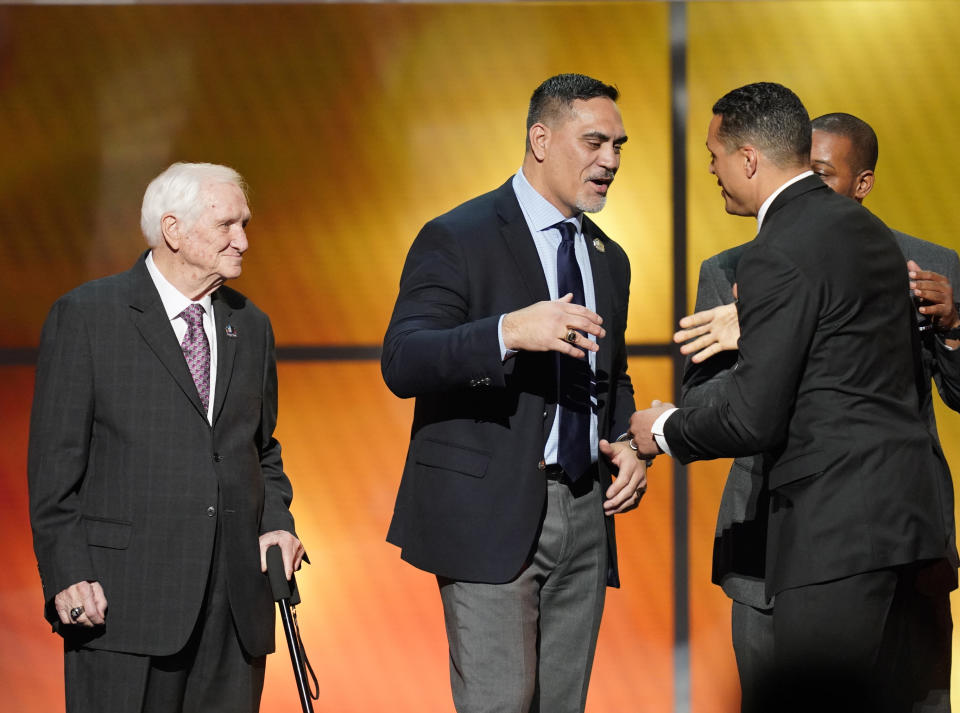 Former Seahawks, Jets and Titans center Kevin Mawae, center, has asked his wife, Tracy, to present him at the Pro Football Hall of Fame induction next month. (AP) 