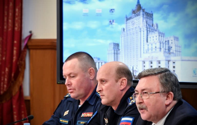 Russian Foreign Ministry's Security and Disarmament Department head Mikhail Ulyanov (R) and others hold a briefing about a UN report which blamed a sarin gas attack in Syria's Khan Sheikhun on Bashar al-Assad's regime, in Moscow on November 2, 2017