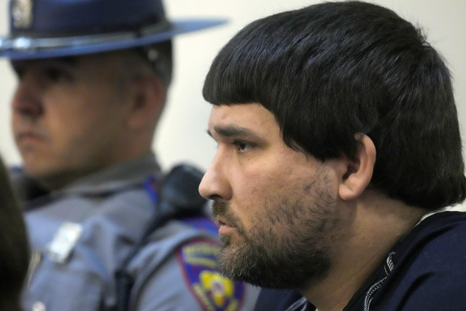 Joshua Hartfield, a former City of Richland police officer and one of six former Mississippi law enforcement officers who pleaded guilty to a long list of state and federal charges, listens as the victims' impact statements, are read in the Rankin County Circuit Court prior to the state sentencing for his involvement in the 2023 racially motivated torture of two Black men, Wednesday, April 10, 2024, in Brandon, Miss. Time served for the state convictions will run concurrently with the federal sentences, and the men will serve their time in federal penitentiaries. (AP Photo/Rogelio V. Solis)