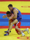 Adam Wheeler (blue) of the USA gets to grips with Mirko Englich (red) of Germany in the Men's Greco-Roman 96kg semi final bout at the China Agriculture University Gymnasium during Day 6 of the Beijing 2008 Olympic Games on August 14, 2008 in Beijing, China. (Ezra Shaw/Getty Images)