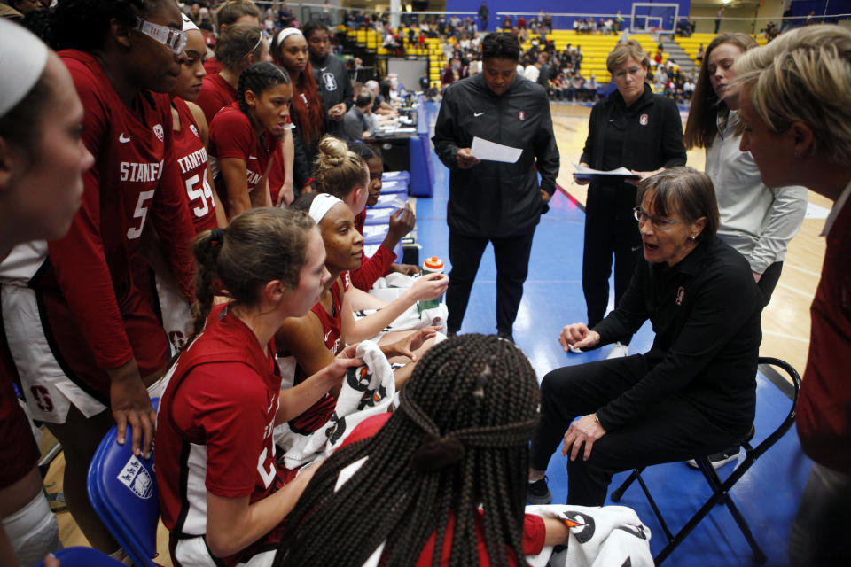 Stanford head coach Tara VanDerveer, seated, goes over a play during a timeout during the third quarter of an NCAA college basketball game against Mississippi State, in Victoria, British Columbia, Saturday, Nov. 30, 2019. (Chad Hipolito/The Canadian Press via AP)