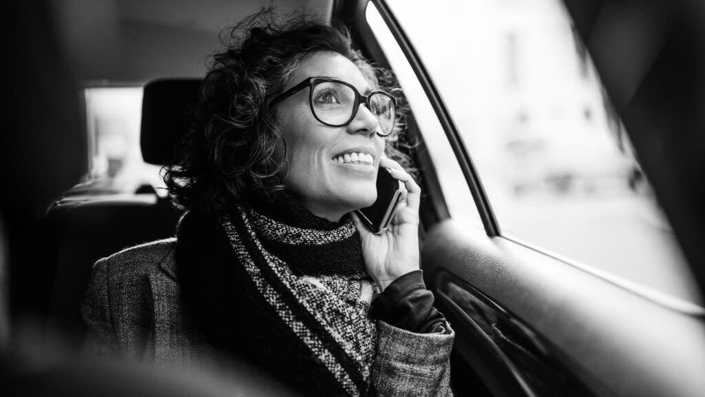 A woman speaking on her cellphone in a car