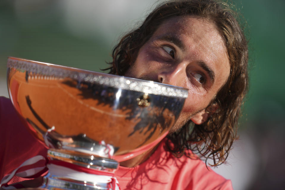 Stefanos Tsitsipas of Greece kisses the trophy after defeating Casper Ruud of Norway to win the Monte Carlo Tennis Masters final match 6-1, 6-4 in Monaco, Sunday, April 14, 2024. (AP Photo/Daniel Cole)