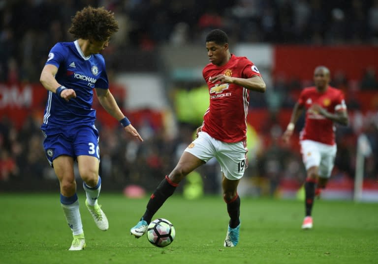 Manchester United's striker Marcus Rashford (R) takes on Chelsea's defender David Luiz (L) during the English Premier League football match between Manchester United and Chelsea at Old Trafford in Manchester, north west England, on April 16, 2017