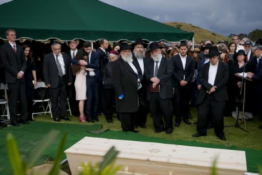 Rabbi Yisroel Goldstein (C), who was wounded in the shooting at Chabad of Poway Synagogue near San Diego, California, stands with mourners during the burial service for victim Lori Gilbert Kaye