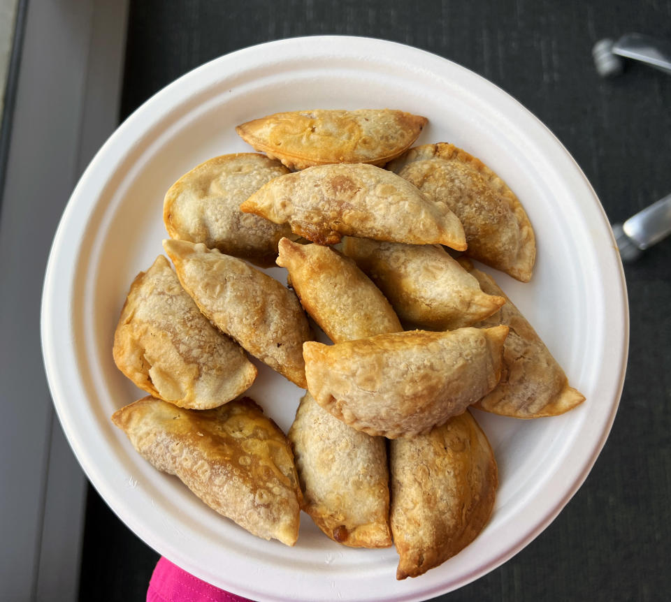 A pile of mini empanadas on a white plate. (Samantha Kubota / TODAY)