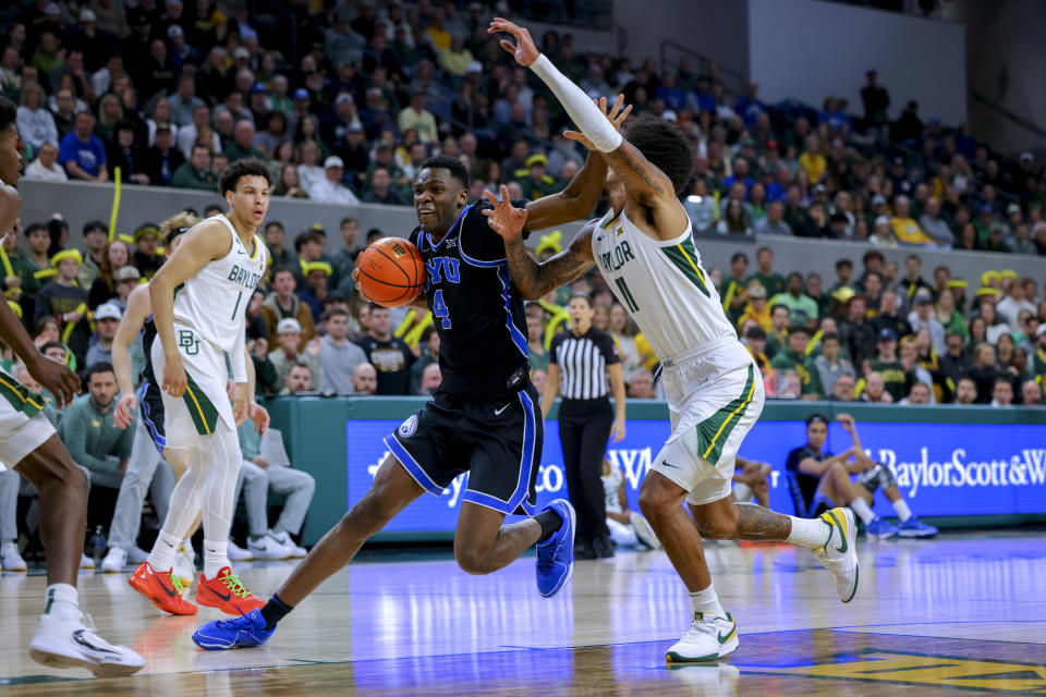 BYU forward Atiki Ally Atiki (4) drives to the basket as Baylor forward Jalen Bridges (11) defends during the first half of an NCAA college basketball game Tuesday, Jan. 9, 2024, in Waco, Texas. (AP Photo/Gareth Patterson)