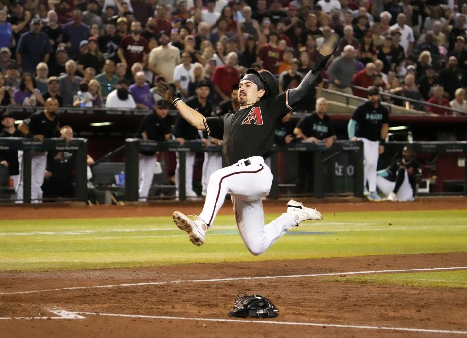 Arizona Diamondbacks Corbin Carroll (7) scores on a throwing error by San Francisco Giants catcher Patrick Bailey (14) after stealing third base in the second inning at Chase Field in Phoenix on Sept. 19, 2023.
