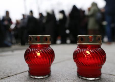 Lit candles are placed on the ground as people gather to attend a memorial service before the funeral of Russian leading opposition figure Boris Nemtsov in Moscow, March 3, 2015. REUTERS/Maxim Shemetov