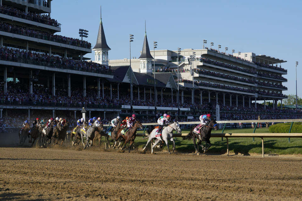 Medina Spirit, right, with John Velazquez aboard, leads the field around the first turn on the way to winning the 147th running of the Kentucky Derby at Churchill Downs, Saturday, May 1, 2021, in Louisville, Ky. (AP Photo/Michael Conroy)