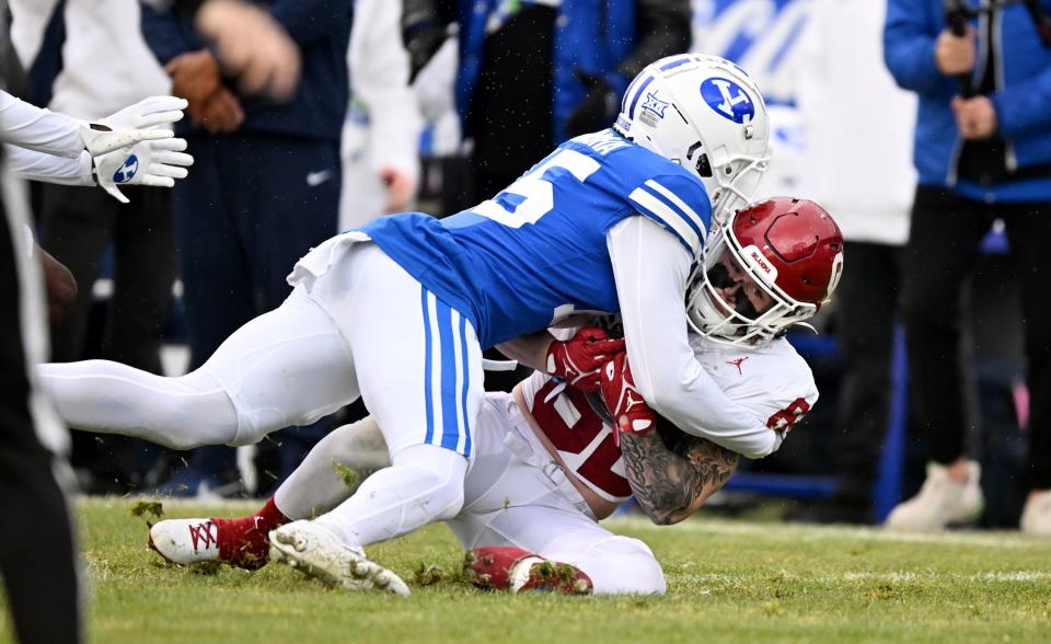 Brigham Young Cougars Chika Ebunoha (15) hits Oklahoma Sooners wide receiver Gavin Freeman (82) immediately during punt coverage as BYU and Oklahoma play at LaVell Edwards Stadium in Provo on Saturday, Nov. 18, 2023. | Scott G Winterton, Deseret News