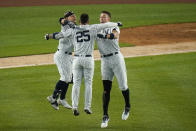 New York Yankees' Gleyber Torres (25) celebrates with Rougned Odor, left, and Aaron Judge, right, after hitting an RBI-single during the ninth inning of a baseball game against the Chicago White Sox, Friday, May 21, 2021, in New York. (AP Photo/Frank Franklin II)