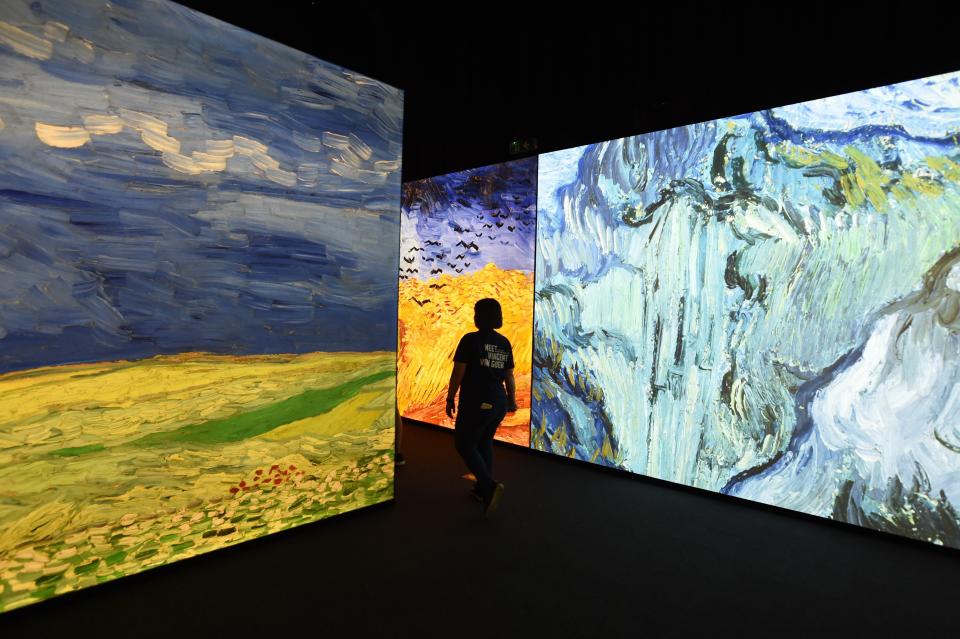 Visitors walk through an exhibition about the life and works of Dutch painter Vincent van Gogh, in Beijing on June 16, 2016. The exhibition, titled "Meet Vincent van Gogh," was created by the Van Gogh Museum and had its global launch in Beijing on June 15. Featuring reproductions of his work and recreations of scenes he painted, the exhibition is scheduled to tour cities across Greater China over the next five years.