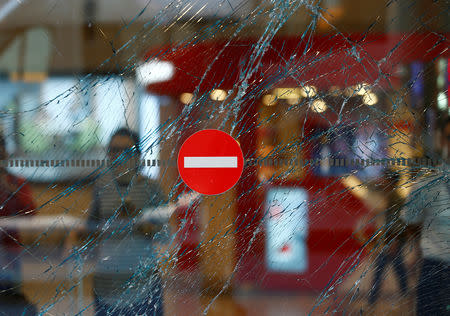 FILE PHOTO: A broken window is seen at Turkey's largest airport, Istanbul Ataturk, Turkey, a day after an attack which killed 45 people, June 29, 2016. REUTERS/Osman Orsal/File Photo