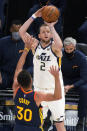 Utah Jazz forward Joe Ingles (2) shoots as Golden State Warriors guard Stephen Curry (30) defends during the second half of an NBA basketball game Saturday, Jan. 23, 2021, in Salt Lake City. (AP Photo/Rick Bowmer)