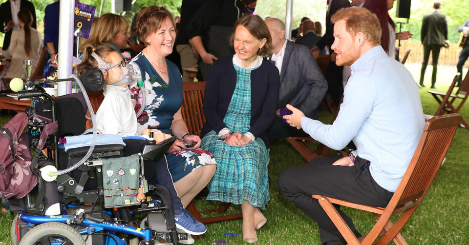 Prince Harry speaking with sick children