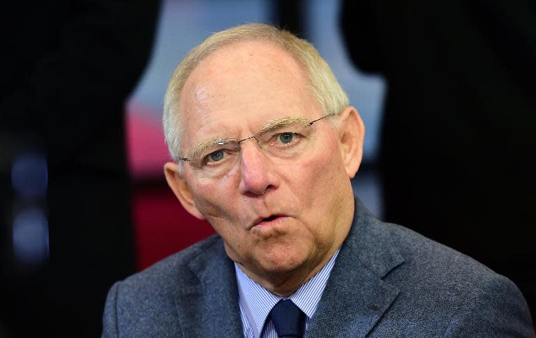 German Finance Minister Wolfgang Schaeuble speaks to journalists upon his arrival for a Eurozone finance ministers meeting in Brussels, on December 8 2014