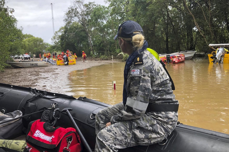 Royal Australian Navy personnel work with civilian emergency services to evacuate members of the public in Cairns, Australia, Monday, Dec. 18, 2023. Officials say more than 300 people have been rescued from floodwaters in northeast Australia, with dozens of residents clinging to roofs. (Australian Defense Dept via AP)