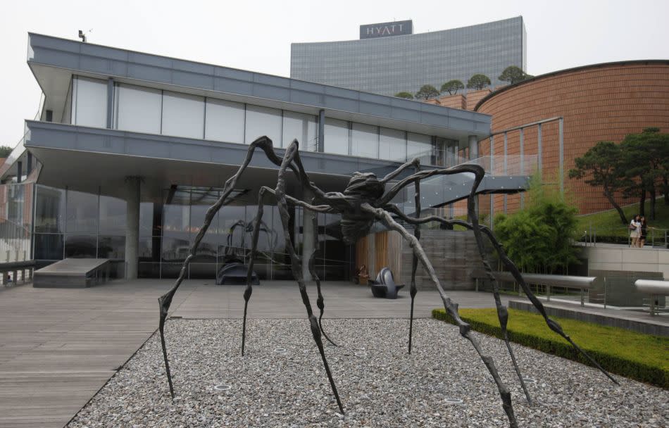 People walk past a spider sculpture by artist Louise Bourgeois at the Leeum Gallery in Seoul. Run by the Samsung Foundation of Culture, the museum consists of two sections that house Korean and contemporary art.