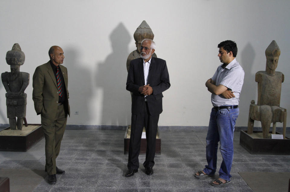 National Museum of Afghanistan director Omara Khan Massoudi, center, speaks to reporters in Kabul, Afghanistan, Friday, June, 28, 2013. Looters stole tens of thousands of artifacts from the National Museum of Afghanistan during the country's civil war in the 1990s, and then thousands more were destroyed by the Taliban when they took power. Now the museum is slowly coming back to life, helped by millions of dollars in U.S. and other foreign aid. Every day 300 to 400 visitors a day come to see the collections of sculptures, jewelry, coins and other artifacts dating from the Stone Age through the 20th century.(AP Photo/Ahmad Jamshid)