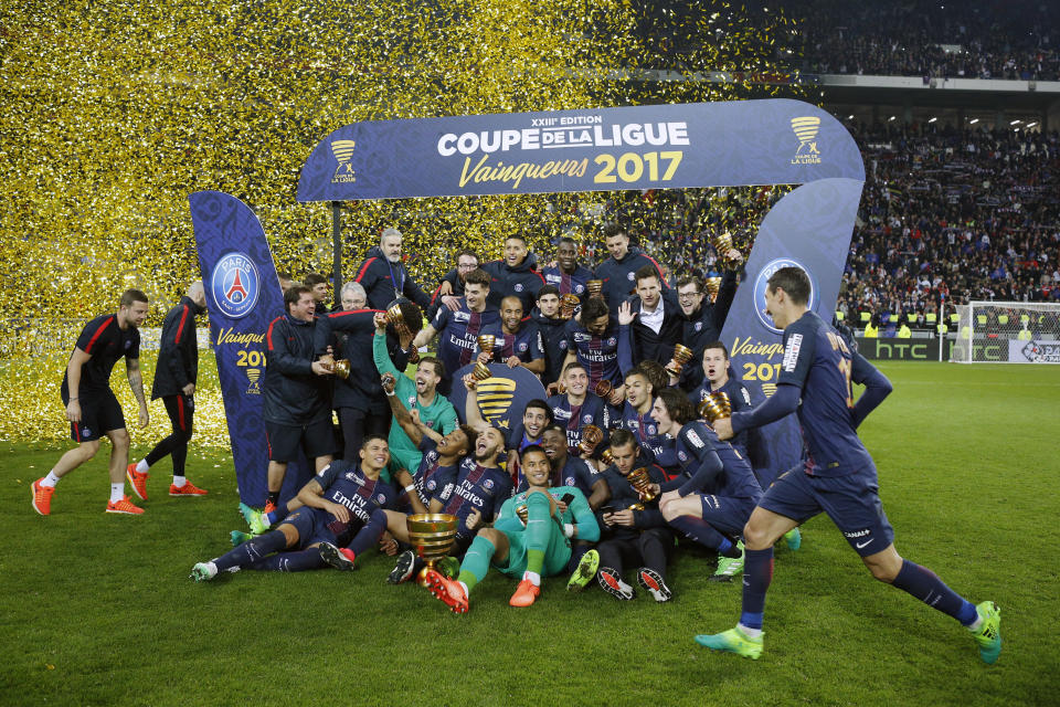 Paris Saint Germain' players celebrate with their trophies after winning the League Cup final soccer match against Monaco, in Decines, near Lyon, central France, Saturday, April 1, 2017. (AP Photo/Laurent Cipriani)