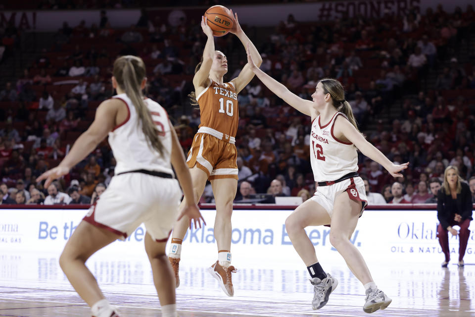 Texas guard Shay Holle (10) shoots against Oklahoma guard Payton Verhulst (12) while guard Lexy Keys looks on during the first half of an NCAA college basketball game Wednesday, Feb. 28, 2024, in Norman, Okla. (AP Photo/Garett Fisbeck)