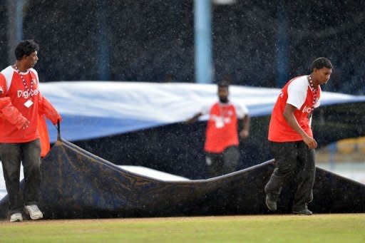 Grounds crews pull out tarps in the second rain delay during the fourth day of the second-of-three Test matches between Australia and West Indies at Queen's Park Oval in Port of Spain, Trinidad. Australia built up a lead of 127 runs over the West Indies on the fourth day of the second Test before heavy rain swamped the Queen's Park Oval and play was abandoned