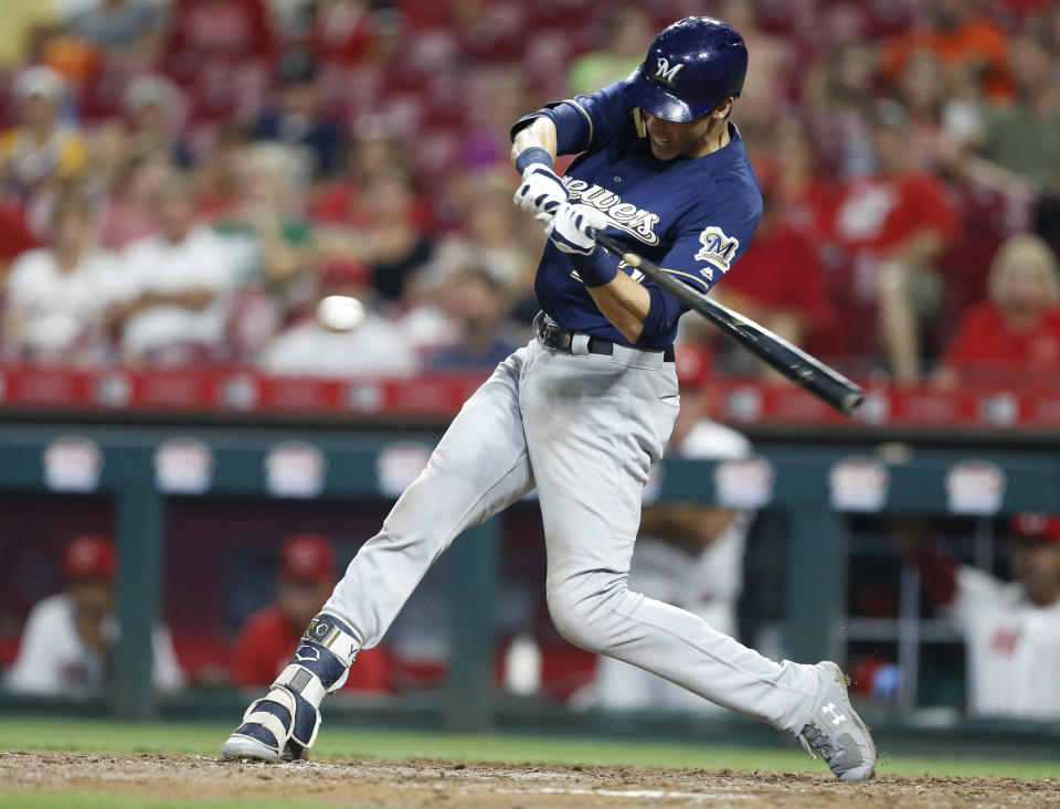 Milwaukee Brewers' Christian Yelich hits a double off Cincinnati Reds relief pitcher Michael Lorenzen during the sixth inning of a baseball game Wednesday, Aug. 29, 2018, in Cincinnati. (AP Photo/Gary Landers)