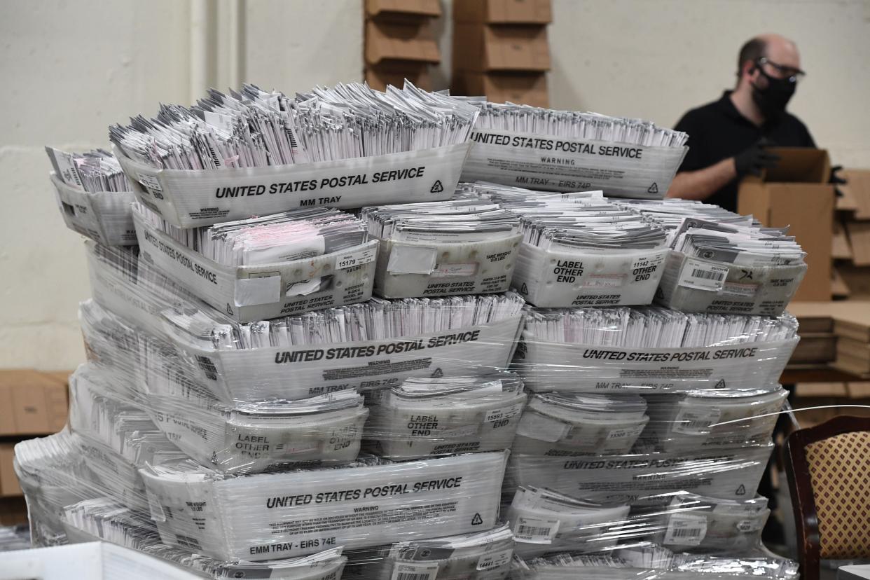 <p>Mail-in ballots in their envelopes await processing at the Los Angeles County Registrar Recorders’ mail-in ballot processing center in Pomona, California, on 28 October</p> ( ROBYN BECK/AFP/Getty)