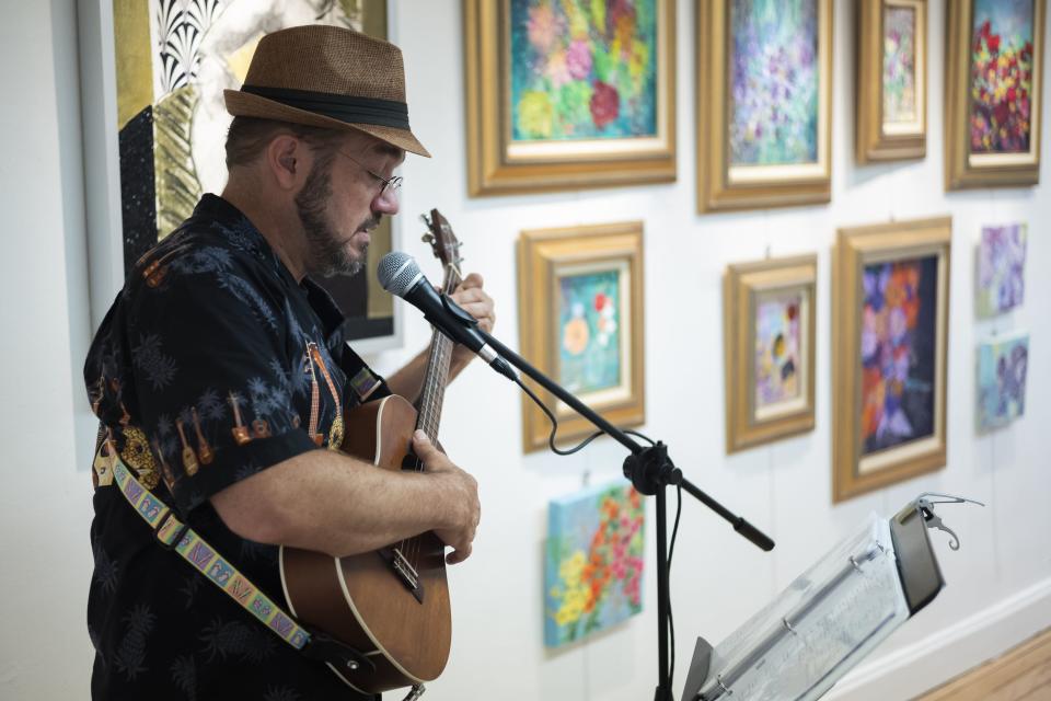 Aaron Minnick, of Columbus. performs during the Hilltop 3060 Art Brunch on Saturday.