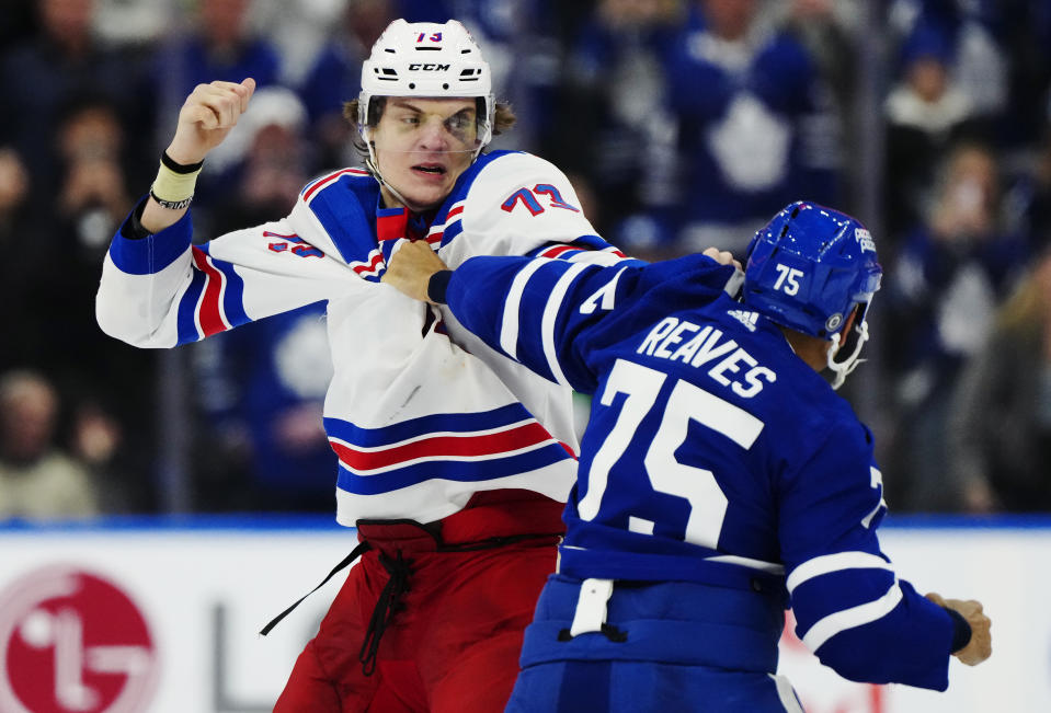 New York Rangers' Matt Rempe (73) and Toronto Maple Leafs' Ryan Reaves (75) fight during the third period of an NHL hockey game in Toronto on Saturday, March 2, 2024. (Frank Gunn/The Canadian Press via AP)