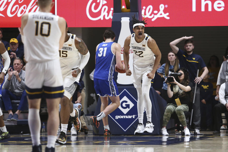 West Virginia forward Josiah Harris (22) reacts after scoring against Buffalo during the first half of an NCAA college basketball game in Morgantown, W.Va., Sunday, Dec. 18, 2022. (AP Photo/Kathleen Batten)