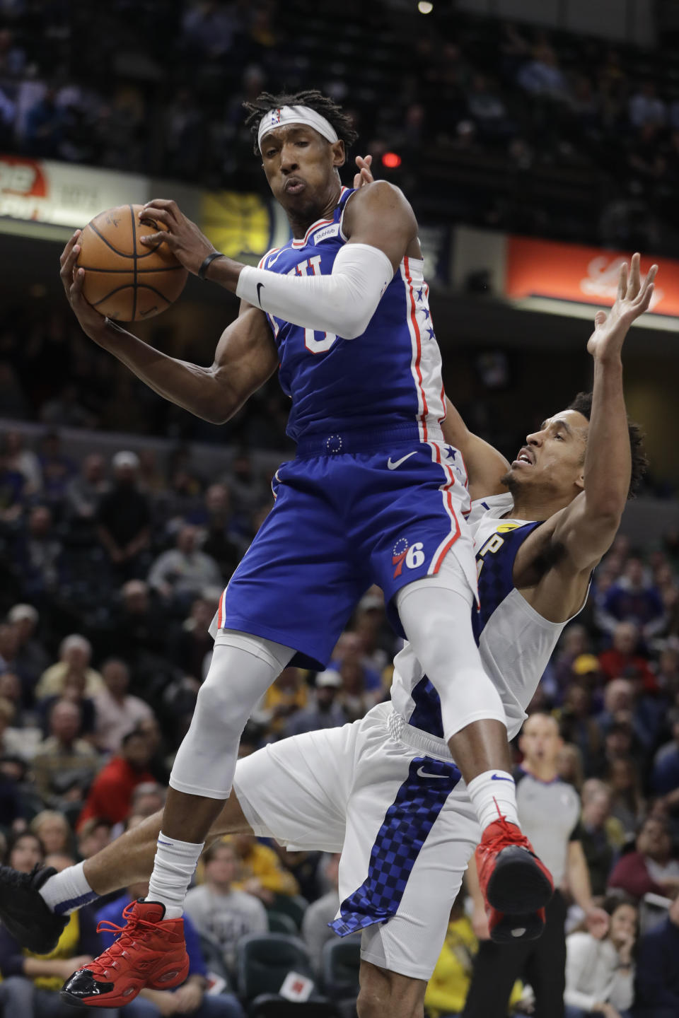 Philadelphia 76ers' Josh Richardson grabs a rebound against Indiana Pacers' Malcolm Brogdon (7) during the second half of an NBA basketball game, Monday, Jan. 13, 2020, in Indianapolis. Indiana won 101-95. (AP Photo/Darron Cummings)
